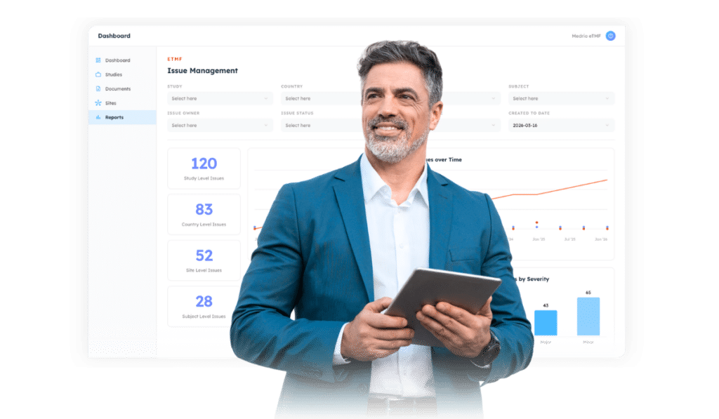 business man holding tablet with Medrio eTMF platform screenshot in the background